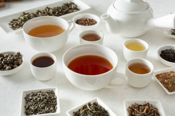 istock tea cups, tea liquor, tea leaves 2184842725