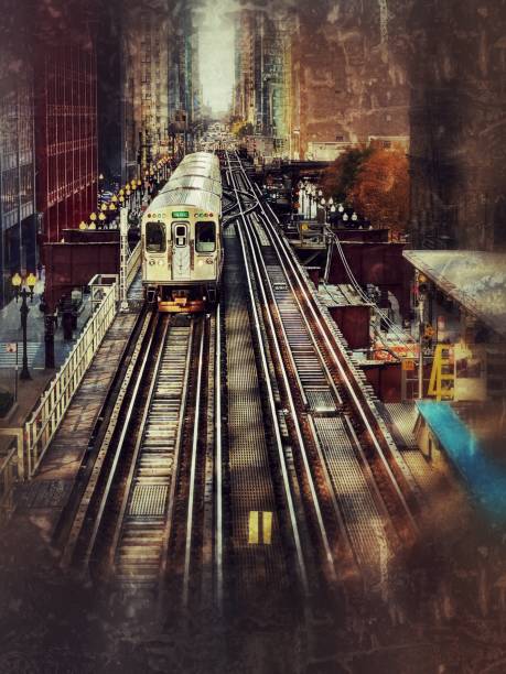 Chicago silver colored commuter train, L-train,  moving on elevated tracks  in between urban office city buildings in Chicago, Illinois, USA