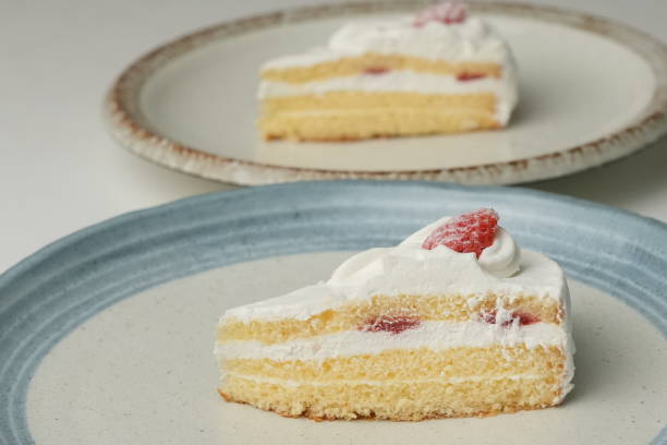 istock Two Japanese strawberry shortcakes on a stylish large plate on a white table 2184843346