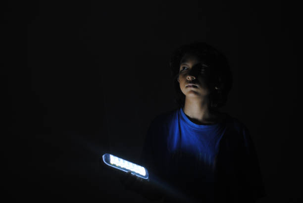 istock Girl bringing a flashlight in the dark. 2184844719
