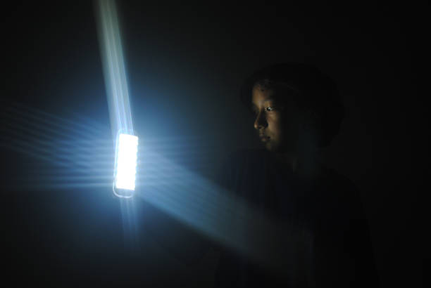 Digital Composite Image Of Young Woman And Light Trails At Night