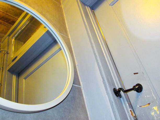 istock Public Bathroom Mirrior Reflection With A Yellow Hue Coming From The Ceiling 2184844985