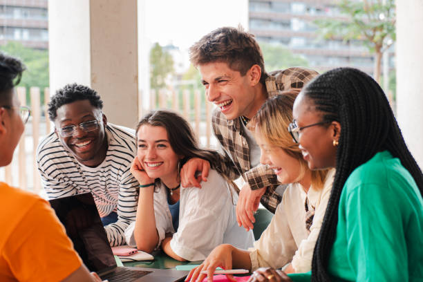 istock Diverse Group of College Students Collaborating on Project with a Laptop. High School Classmates Sharing Joyful Moment During Study Session: Modern Education and Inclusive Learning Environment 2184848582