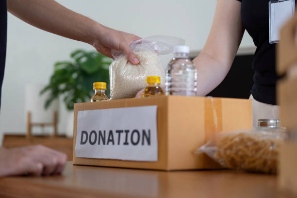 istock Volunteers Packing Food Donations for Community Service Project 2184850866