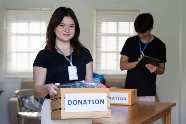 istock Volunteer Enthusiastically Sharing Efforts Through Donation Management 2184850892