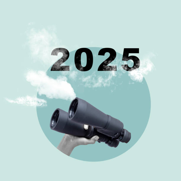 istock Human hand holding binoculars and looking at 2025 with colored background 2184856588