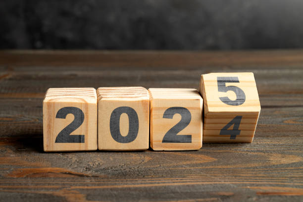istock Wooden blocks transform from number 2024 to 2025 on the table 2184857981