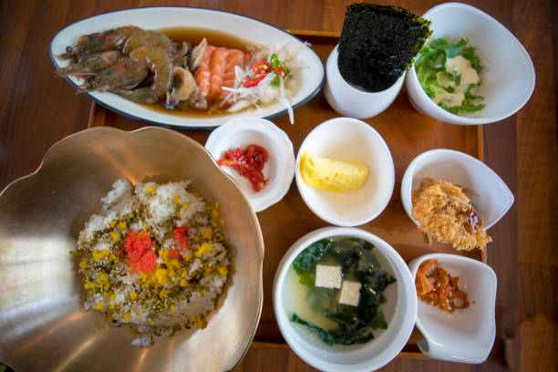 This is a table setting of assorted Korean dishes, including soy sauce marinated crab and shrimp marinated crab.