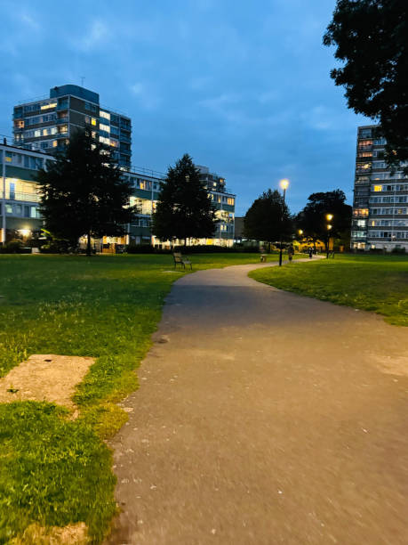 istock Evening Park Path Among Urban Buildings 2184867183