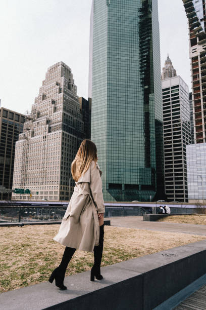 istock Elegant Woman Strolling Through Urban Setting Surrounded by Modern Skyscrapers 2184874782
