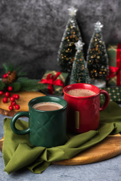 istock Red and green hot chocolate mugs and small Christmas tree 2184875021