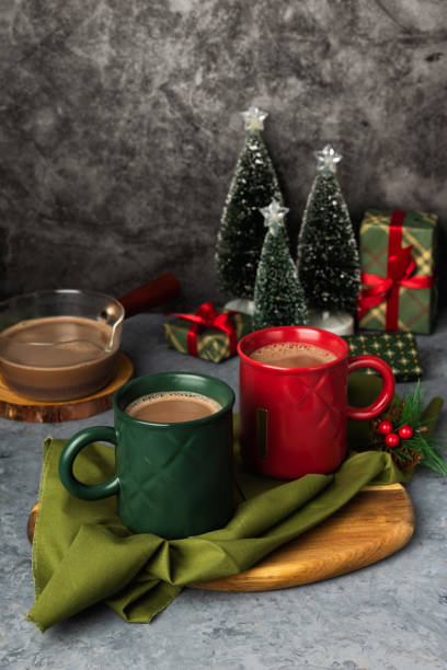 istock Red and green hot chocolate mugs and small Christmas tree 2184875027