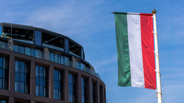 istock Hungarian flag with modern glass building background 2184878589