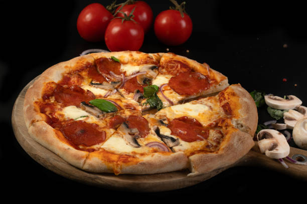 istock Homemade pepperoni pizza on black background 2184885086
