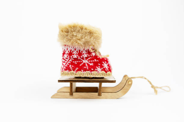 istock Concept Decoration. Red Nicholas Christmas on Sled boots isolated on white background. Winter boots, snow boots. New Year. NATIONAL SHOE THE WORLD DAY. Navidad 2184887424