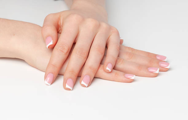 istock Well-groomed female hands with manicure on white background 2184887447
