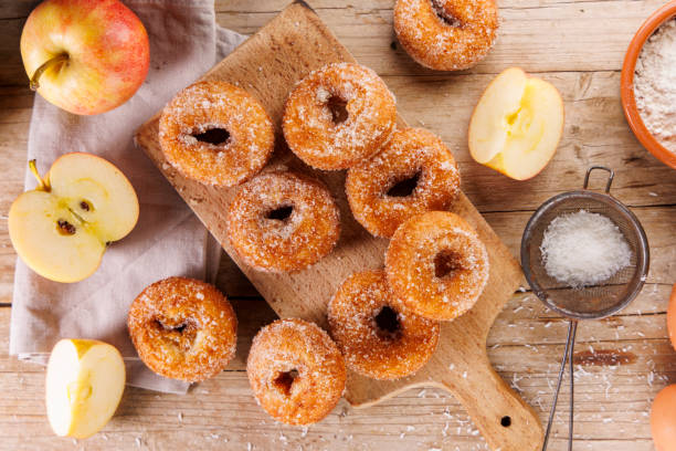 istock delicious apple donut on wooden background 2184889139