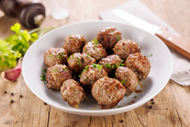 istock grilled meatballs with fresh herbs on wooden background 2184889331