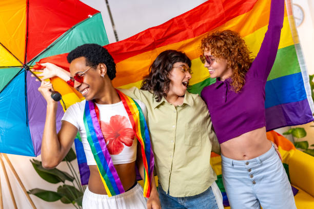 istock Multi-ethnic friends waving lgbt rainbow flag and dancing 2184892269