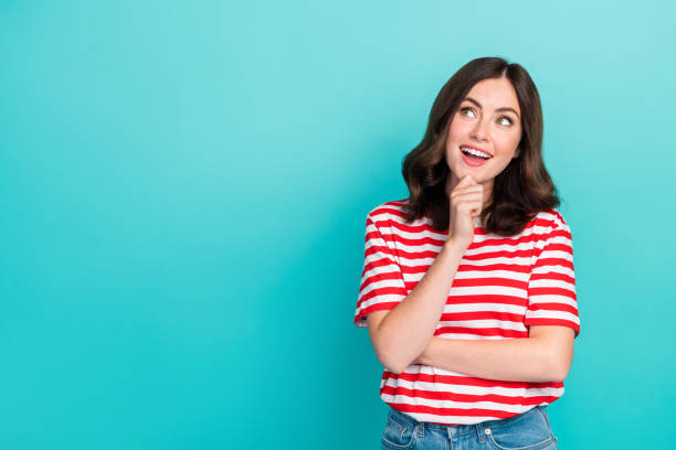 istock Photo of cheerful cute lady interested look empty space consider question decision striped trendy outfit isolated on cyan color background 2184892652