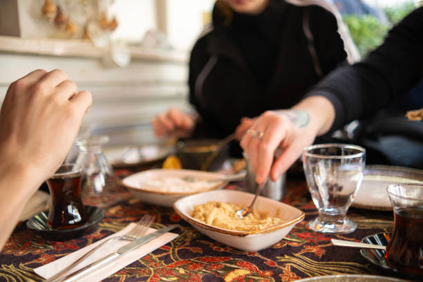 istock Man trying Turkish home-made hummus spread 2184892940