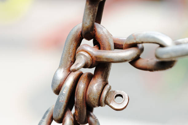 close up metallic aged old rusty chain and lock loop industrial cargo macro photography element with blurred background space