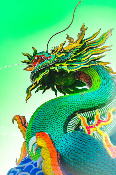 Dragon Series : Green dragon statue against the backdrop of sky. Chinese style dragon statue spraying water. Landmark of Nakhon Sawan Province.