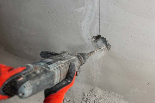 First person view of a hammer drill at work - drilling a hole in a concrete wall
