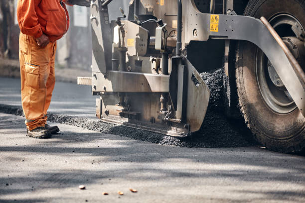 istock Construction workers working on a new asphalt layer on a public street. 2184897628