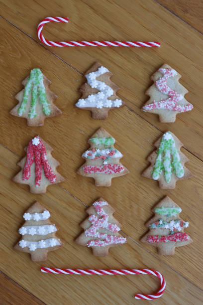 istock Christmas tree shaped gingerbread cookies on wooden table 2184899797