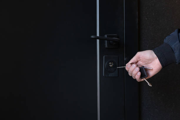 istock Man with key opening front door, closeup, Copy space. 2184900142