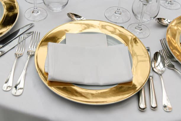 istock Elegant Table Setting with Gold Charger Plates and Silverware 2184903230