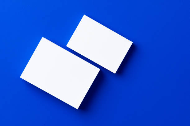 istock Blank white businesscards on classic blue background 2184904291