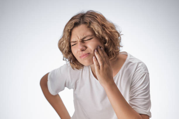 istock Woman Experiencing Toothache in a White T-Shirt 2184905735