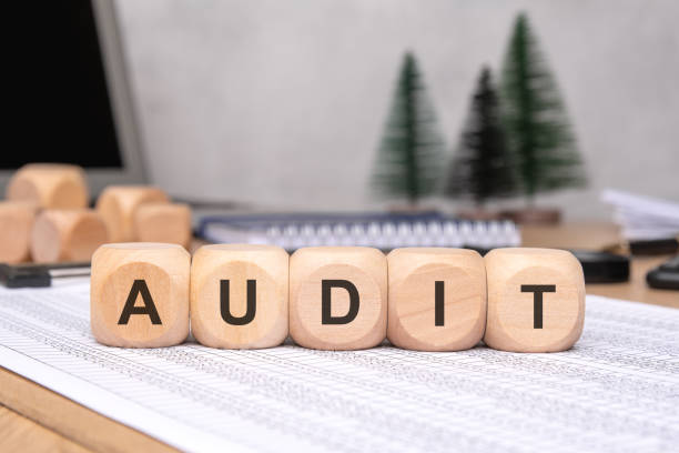 istock The Audit Concept is Illustrated by Using Wooden Blocks Arranged on an Office Desk Surface 2184905996
