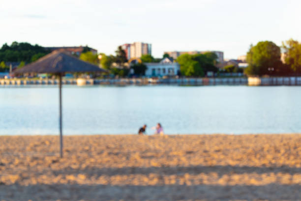 abstract blurred unfocused beach sandy waterfront summer morning space with children silhouettes near water