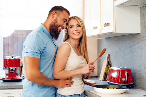 istock Young loving couple cooking together in kitchen 2184906447