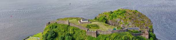 Dumbarton castle building on volcanic rock aerial view from above Scotland Dumbarton castle building on volcanic rock aerial view from above Scotland UK dumbarton castle stock pictures, royalty-free photos & images
