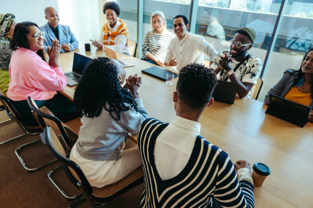 istock Diverse team gathers in a modern boardroom for a company meeting 2184907477