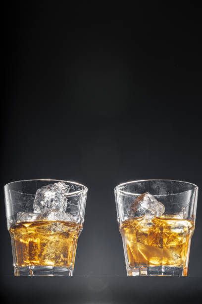 istock Glass of whisky on black background, copy space 2184911040
