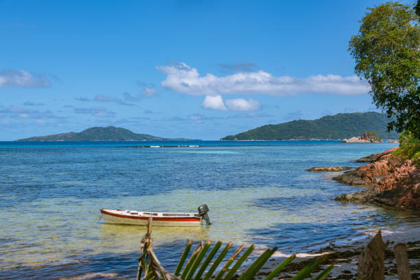 Fisher Boat At Anse La Blague And A Beautiful View To The Islands Felicite And La Digue