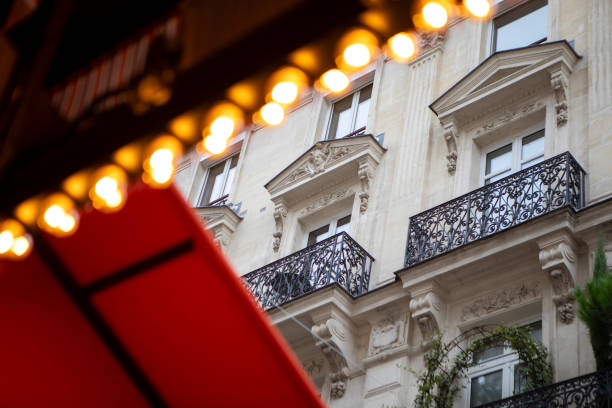 Paris apartment building viewed from under a canopy outside a cafe restaurant