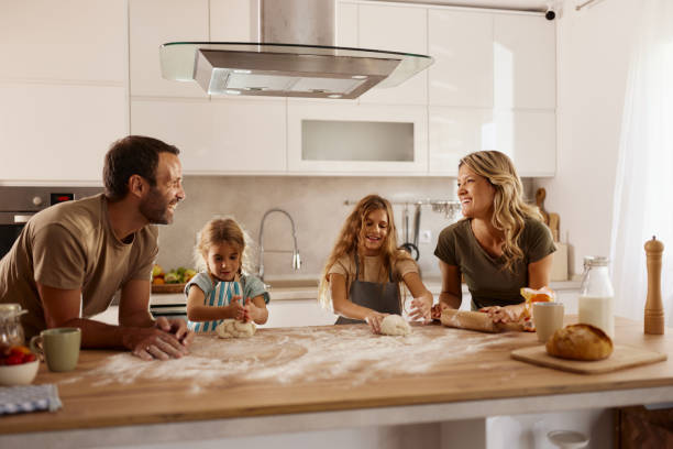 istock Happy family enjoying while making a cake at home. 2184912660