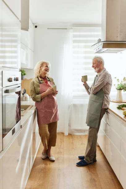 istock Happy senior couple talking during coffee time in the kitchen. 2184912750