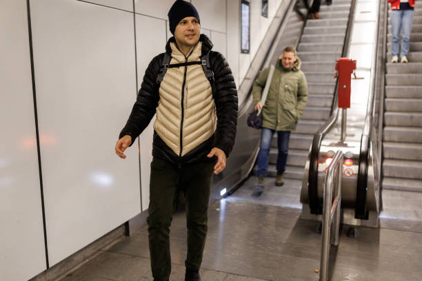 istock Male friends on subway escalator 2184912894