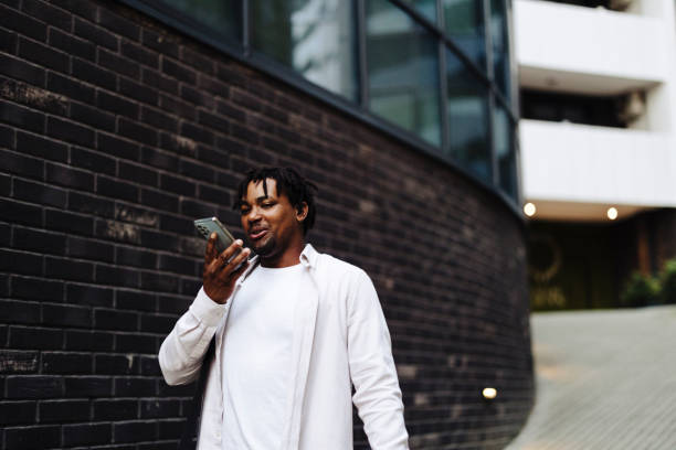 istock Man holding  smartphone near mouth using speakerphone, send audio voice message to friend, using virtual assistant, talking through loudspeaker easy advanced usage of modern tech concept 2184912904