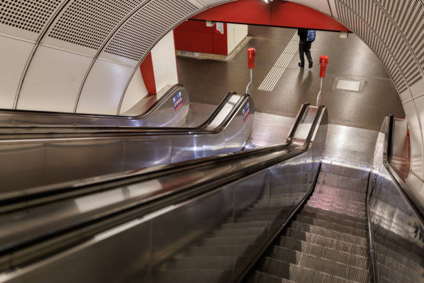 High angle shot of unrecognizable man at the foot of the subway station escalator