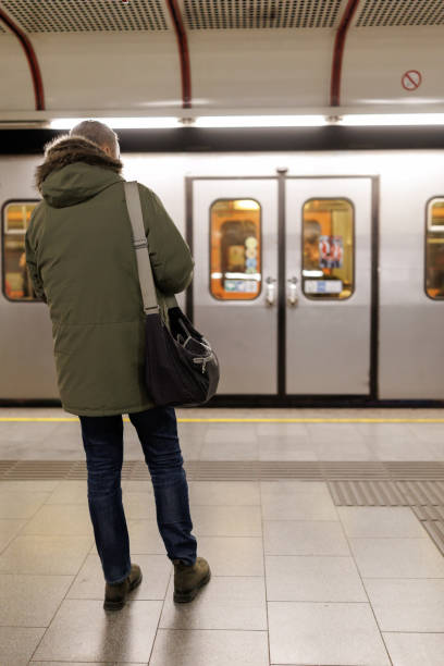 istock Mature man waiting for the train in subway station 2184913587