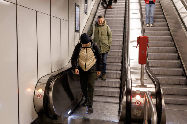 istock Male friends on subway escalator 2184913883