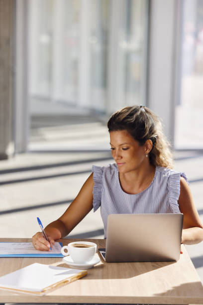 istock Businesswoman taking notes while working on laptop in the office. 2184915308